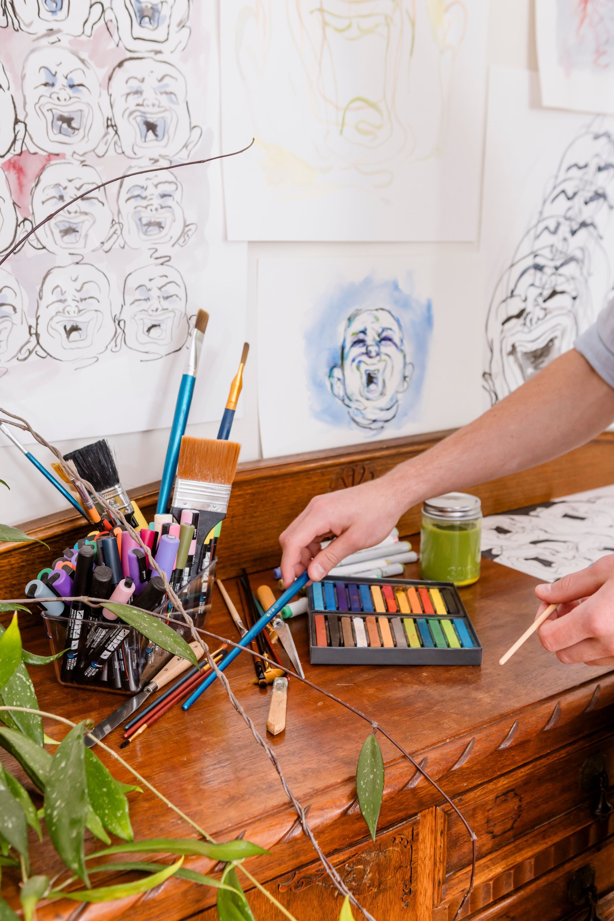 Artistic workspace with paint brushes and pastels